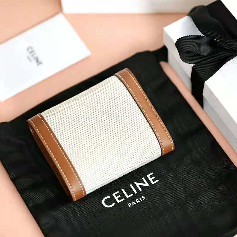 Side profile highlighting gold Triomphe hardware on wallet