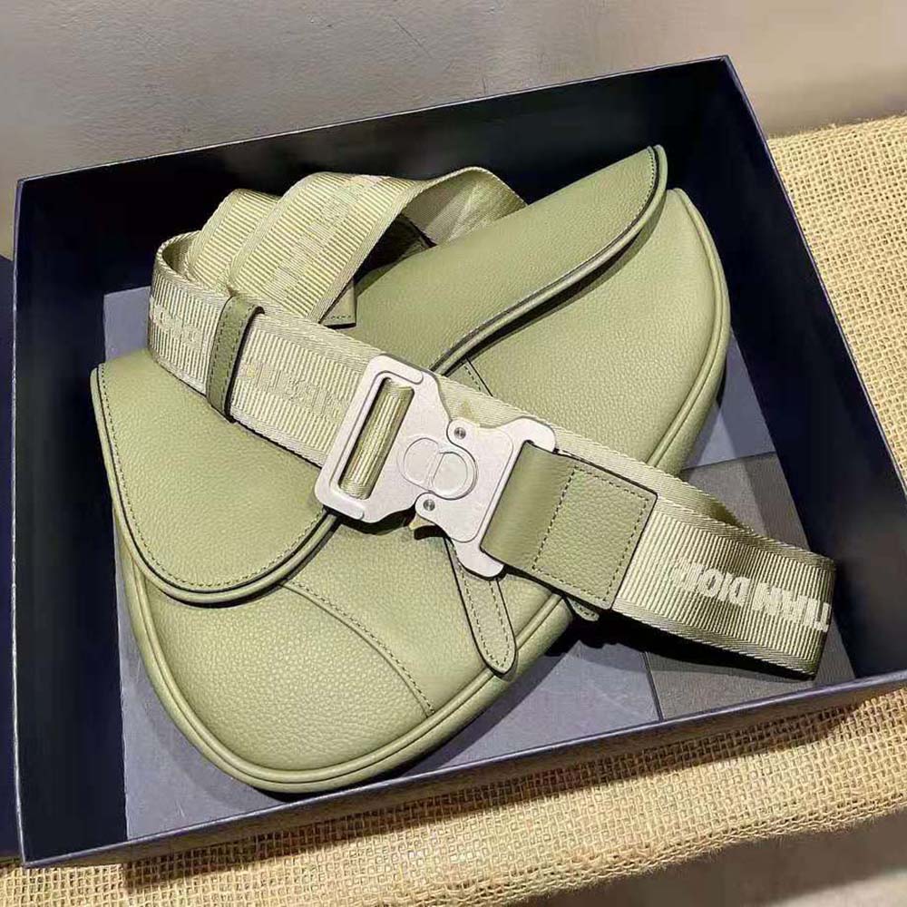 Close-up of Dior Men Saddle Bag Khaki leather texture and gold hardware