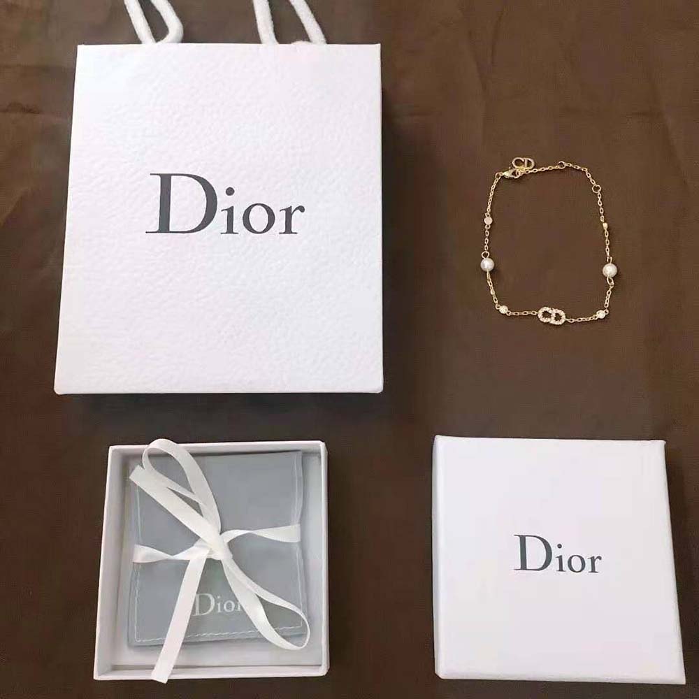 Side angle of Dior Women Clair D Lune Bracelet showing gold finish clasp detail