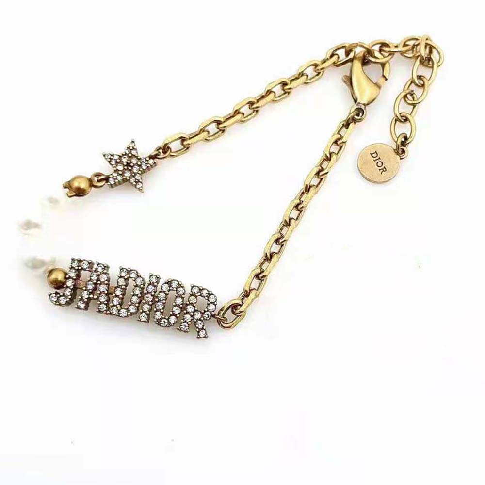Full bracelet laid flat displaying Dior Women J’Adior Bracelet antique gold finish