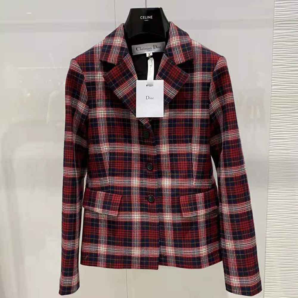 Close-up on signature Dior metal buttons of the Red Black and White Check jacket