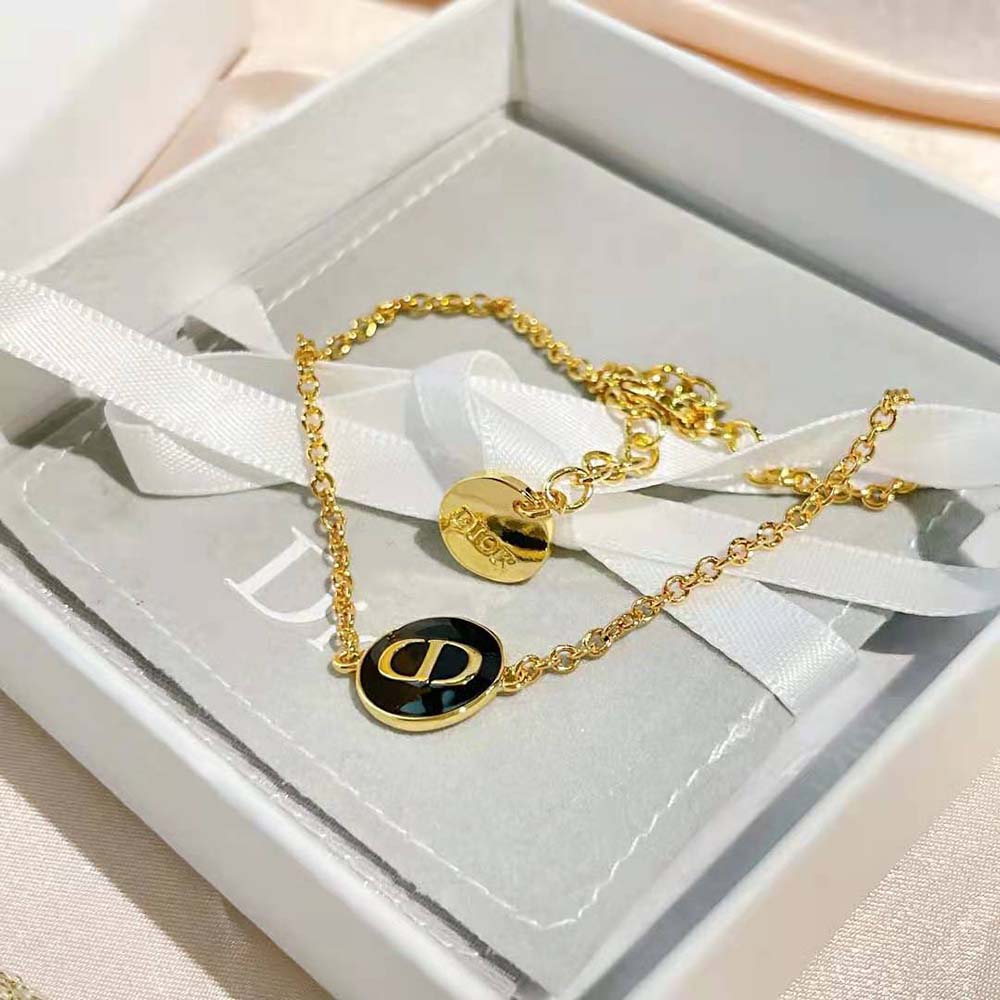 Side angle detail of gold-finish clasp on Dior Women Petit CD Bracelet