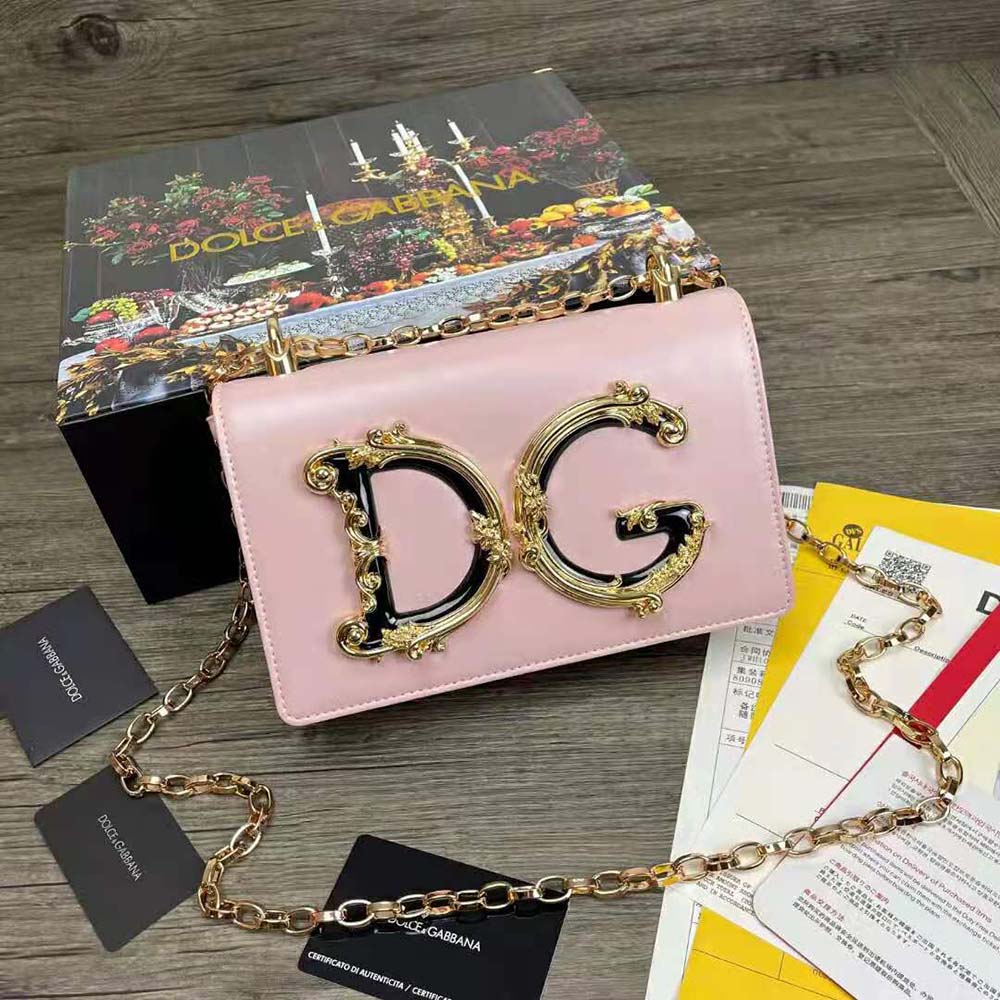 Close-up of gold-tone D&G logo and hardware on pink shoulder bag
