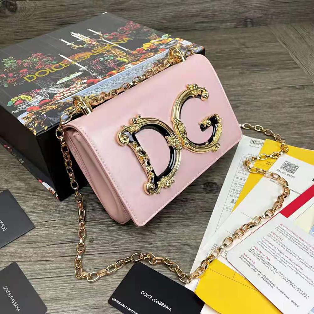 Side angle showcasing strap and structured silhouette of Dolce Gabbana D&G pink bag