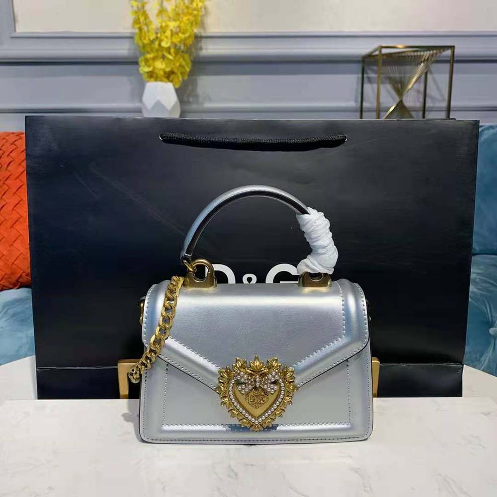 Close-up of gold-tone Devotion clasp on Dolce Gabbana D&G small bag