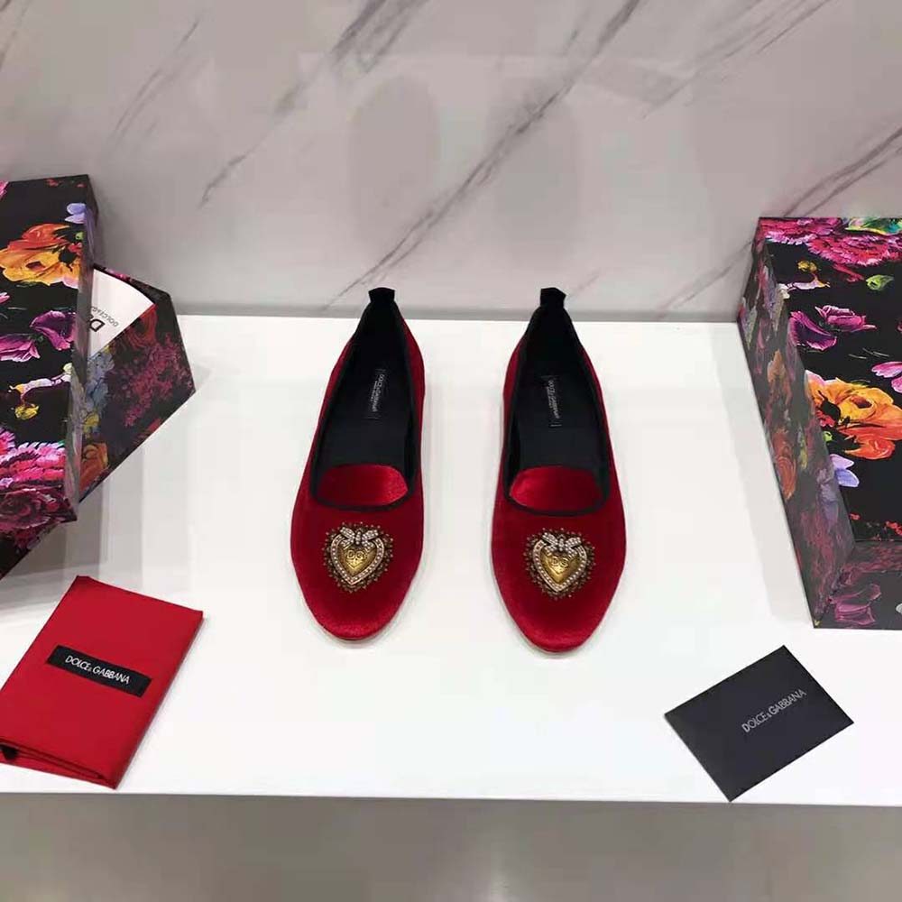 Close-up of gold D&G hardware on red velvet Devotion slippers