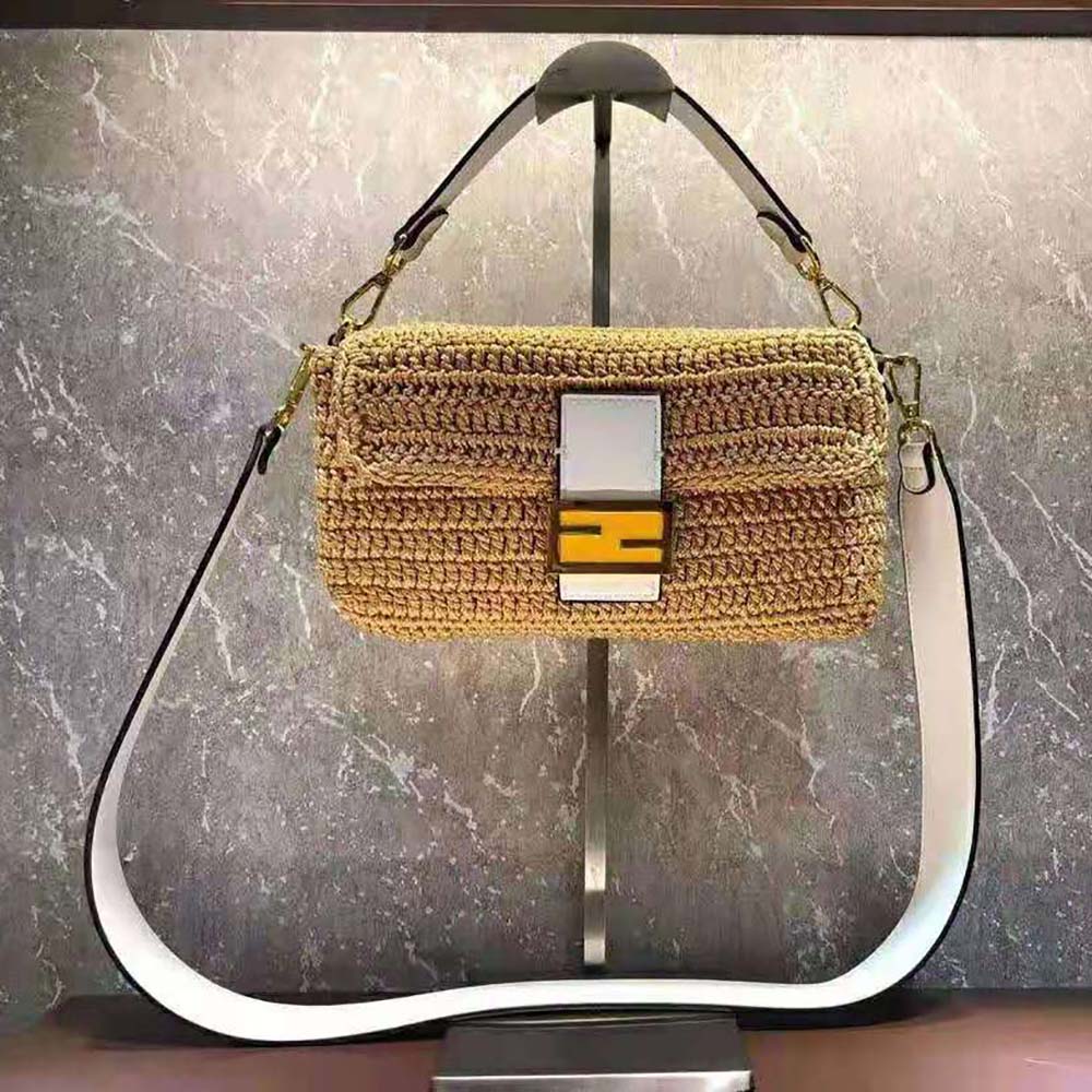 Close-up of orange cotton crochet texture and gold Fendi logo