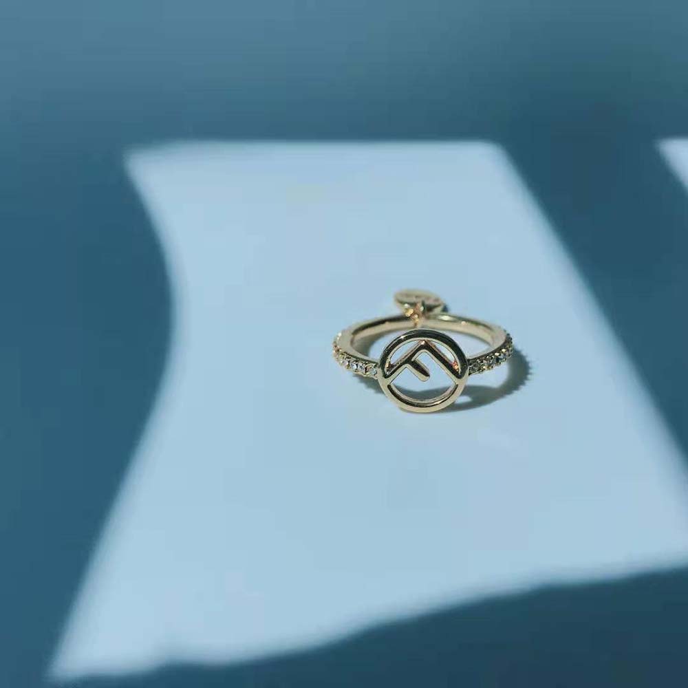 Fendi Women F is Fendi Gold-color Ring on model's hand highlighting adjustable fit