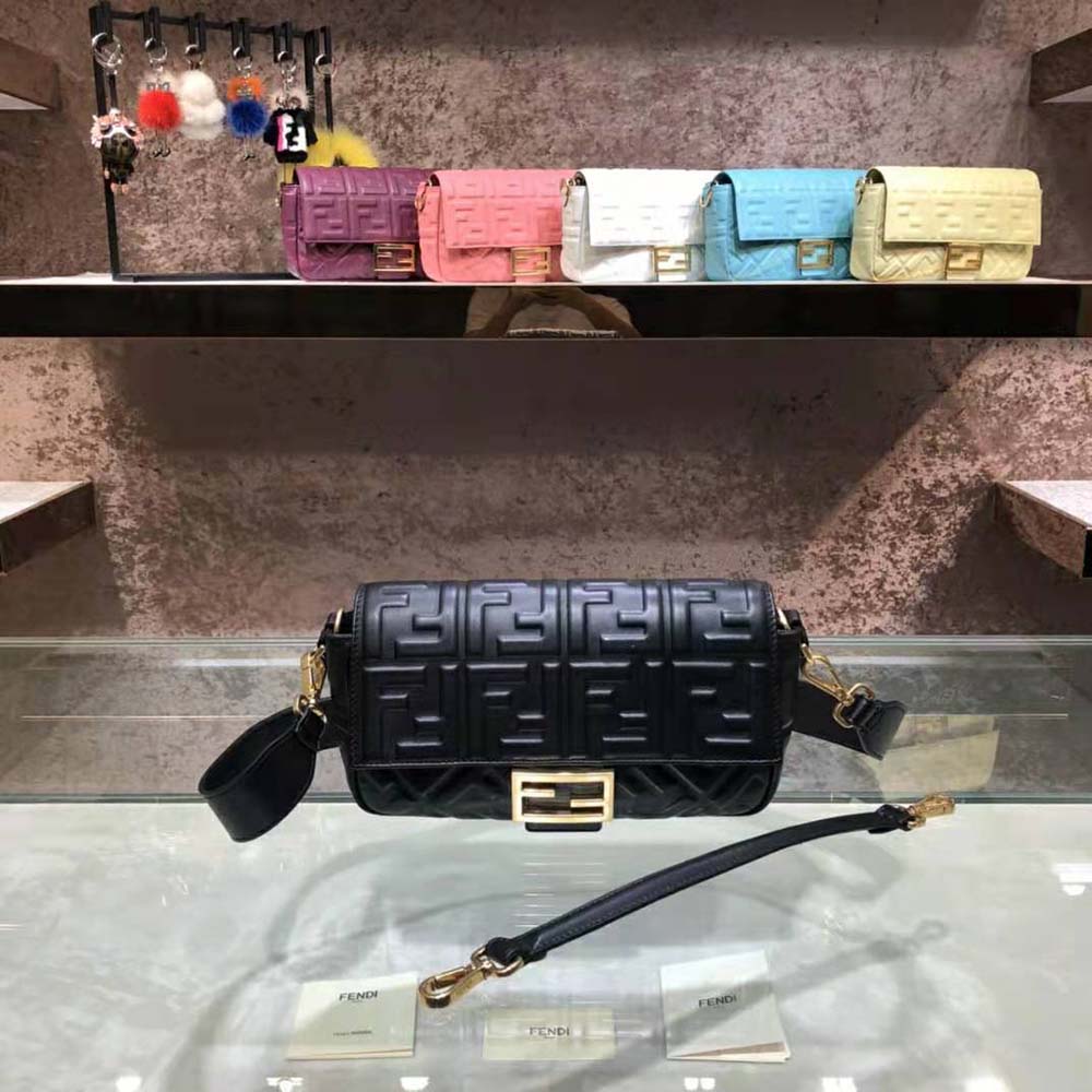 Close-up of gold hardware on Fendi Women Iconic Medium Baguette Black Leather Bag