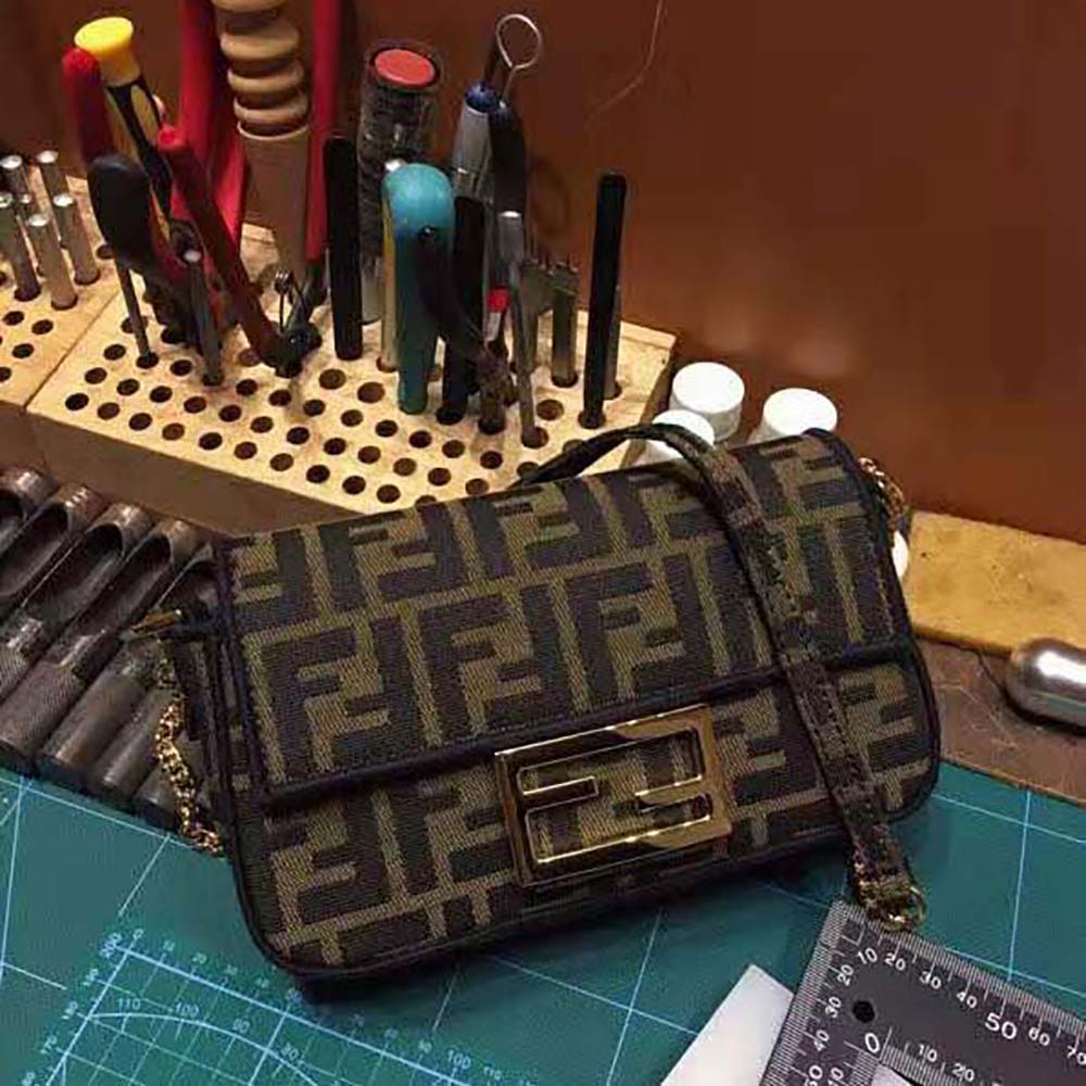 Close-up of gold-tone hardware on Fendi Women Mini Baguette Brown Fabric Bag