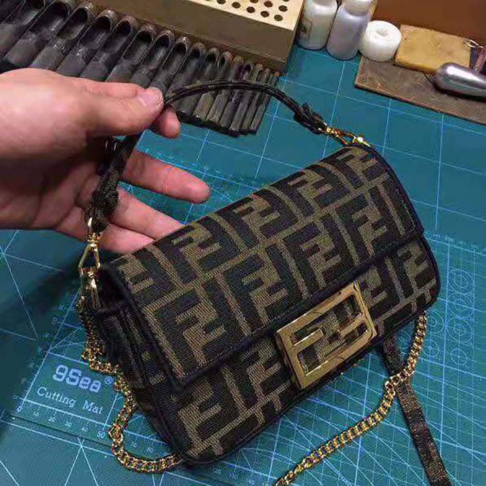 Side angle showing compact silhouette of Fendi Women Mini Baguette Brown Fabric Bag