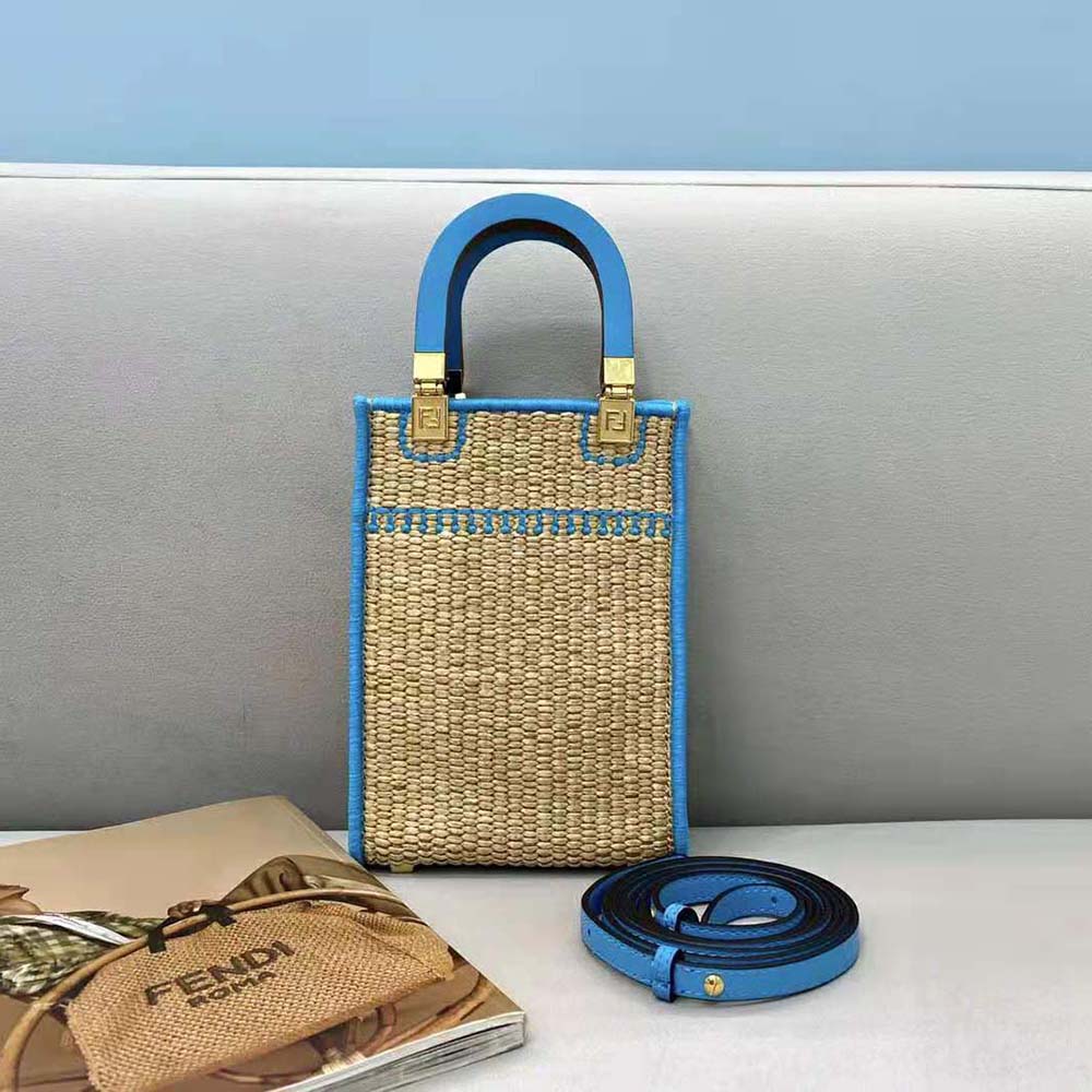 Side angle showing compact shape of Fendi Women Mini Sunshine Shopper bag