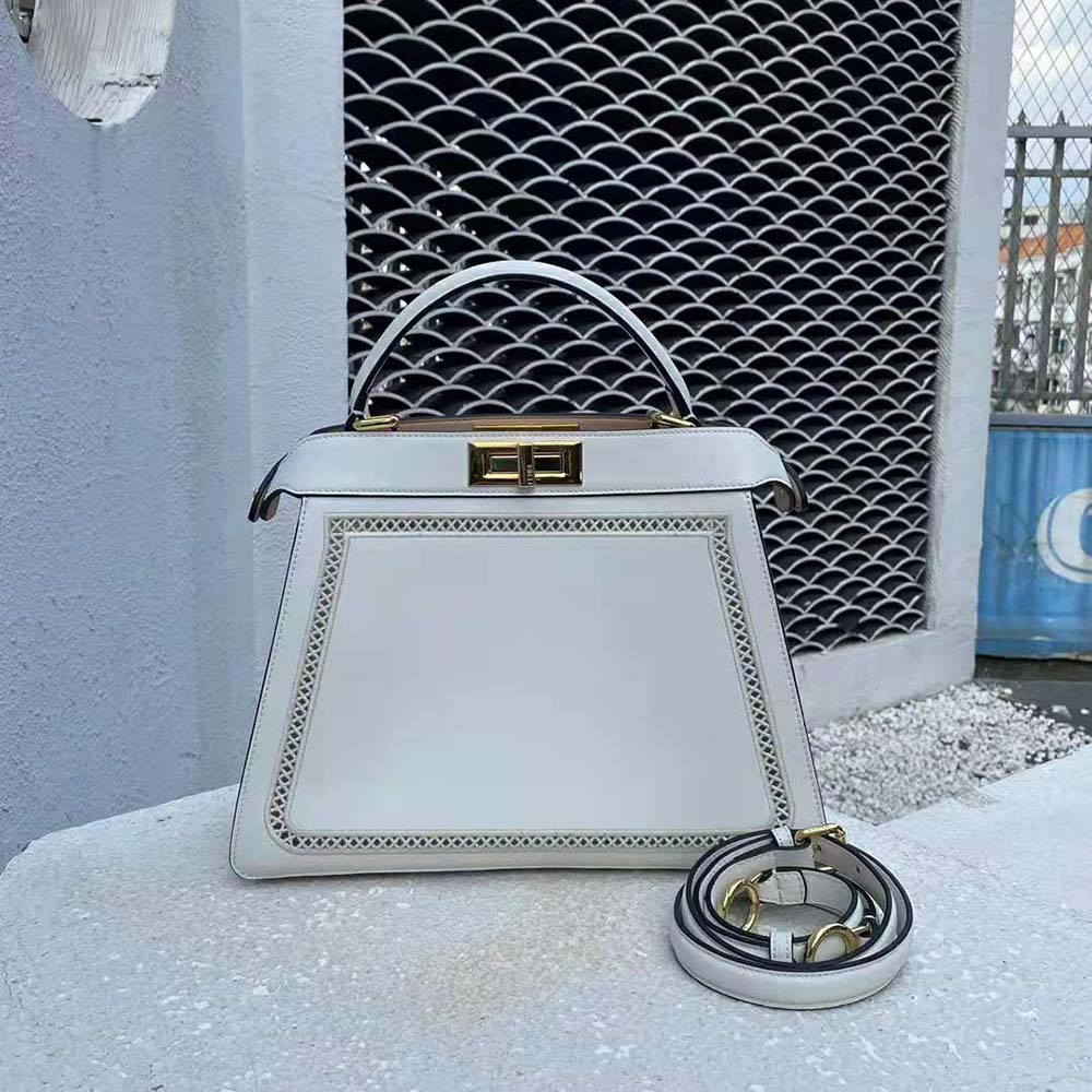 Side angle showing gold hardware on Fendi Women Peekaboo Iseeu Medium White Canvas Bag