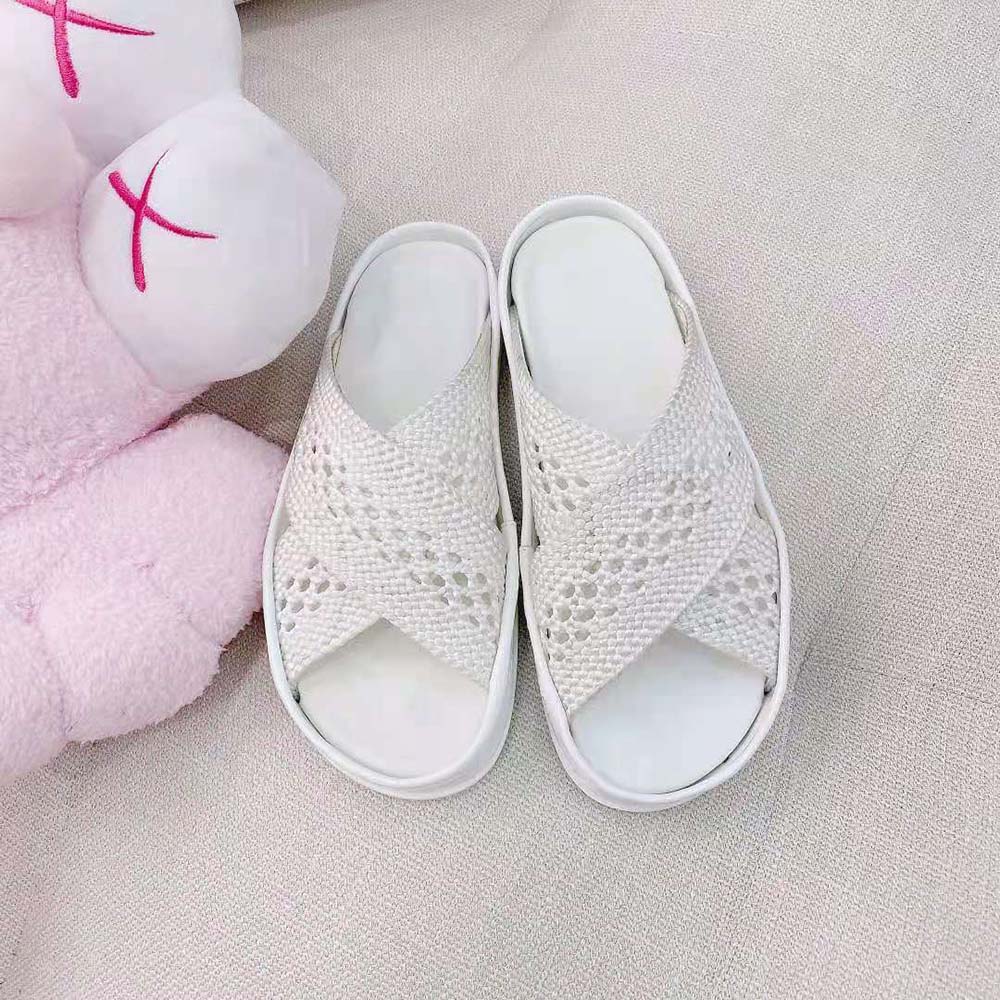 Close-up of white stretch lace and Fendi hardware detail on slides