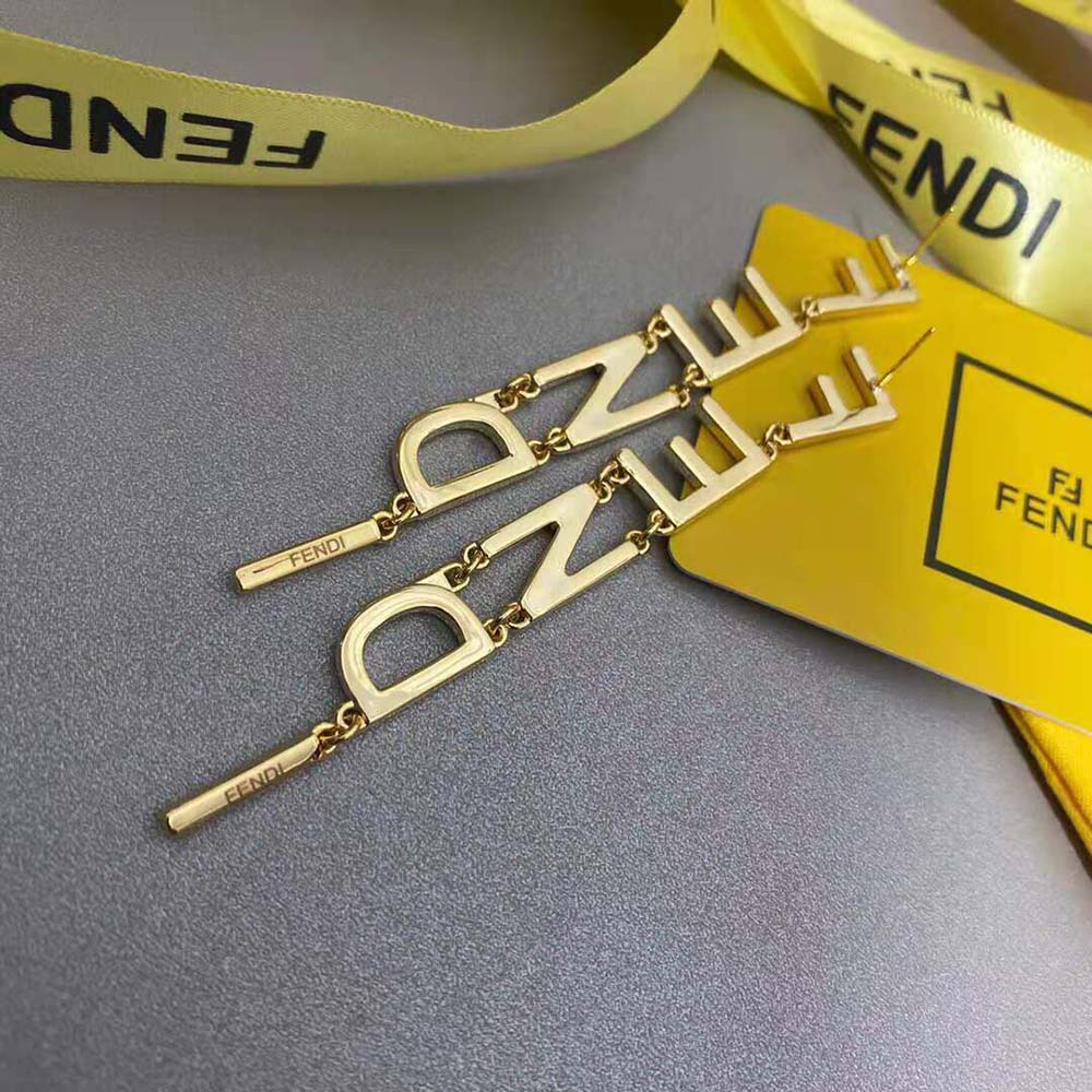 Lifestyle image of Fendi Women Signature Gold-color Earrings worn with elegant outfit