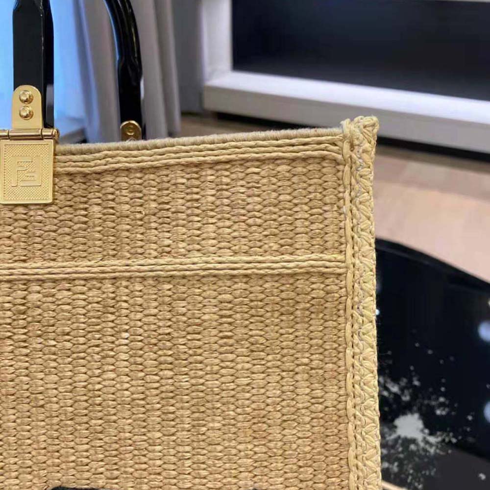 Side angle showing silhouette and zipper closure of Fendi medium straw shopper