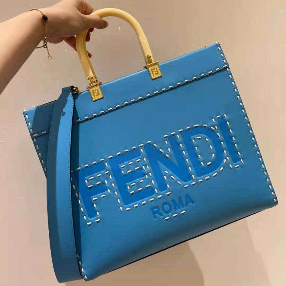 Close-up of blue leather texture and gold hardware on Fendi shopper