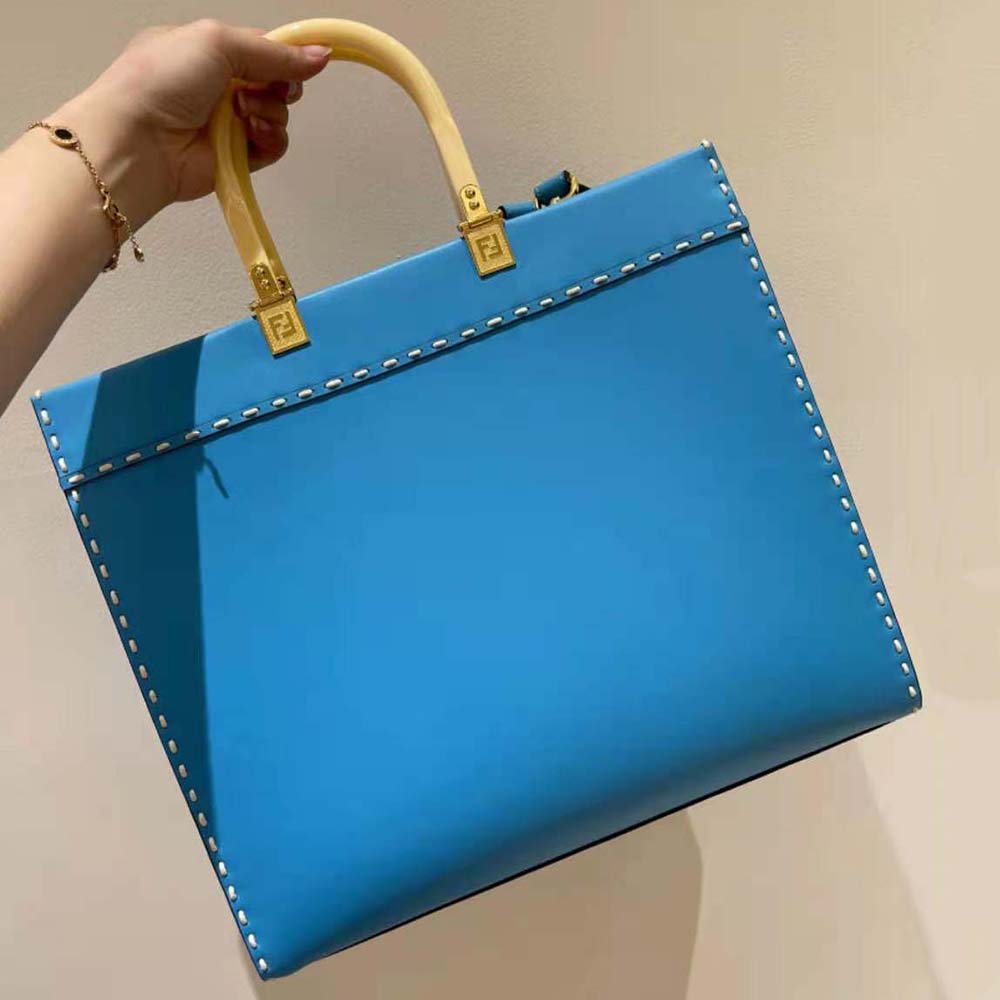 Side angle showing structured silhouette of Fendi Women Sunshine Medium Leather Shopper-Blue