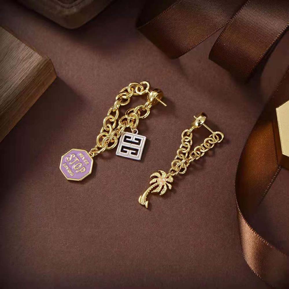 Styled shot of Givenchy Women Charms Asymmetrical Earrings worn with evening attire