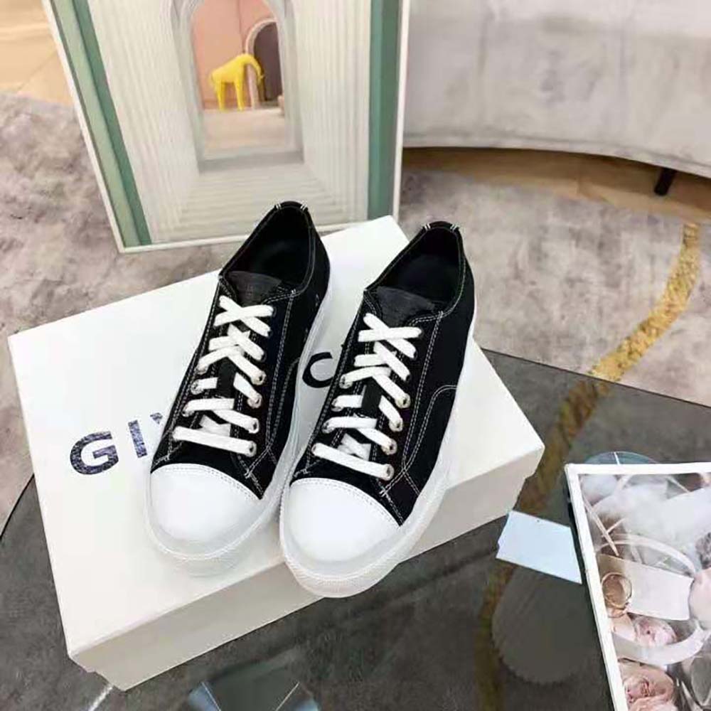 Close-up on the Givenchy logo trim on black leather sneaker