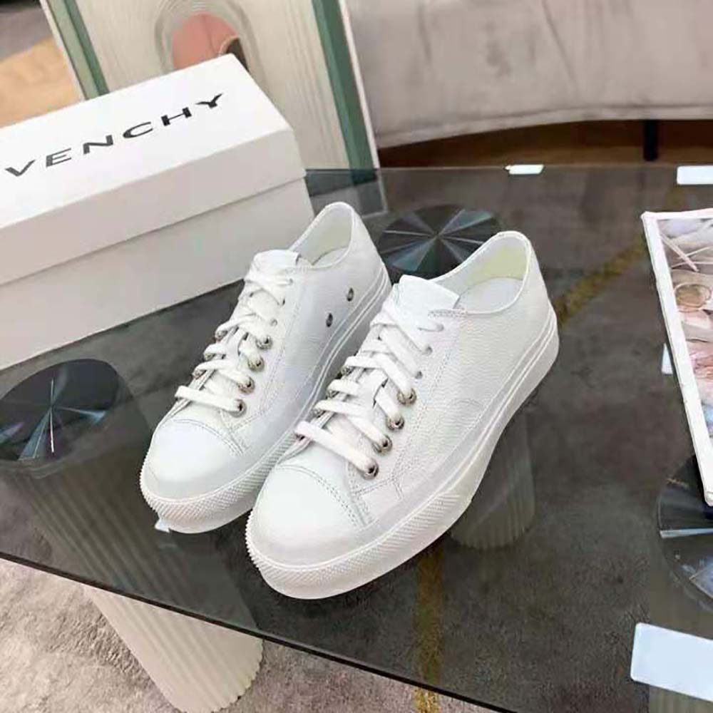 Close-up of Givenchy logo and leather detailing on white sneakers