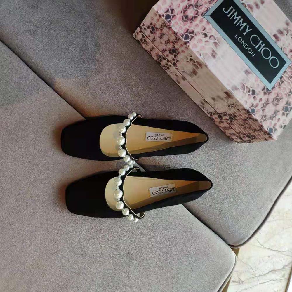 Close-up of pearl embellishment on Jimmy Choo Women Ade Black Suede Flats