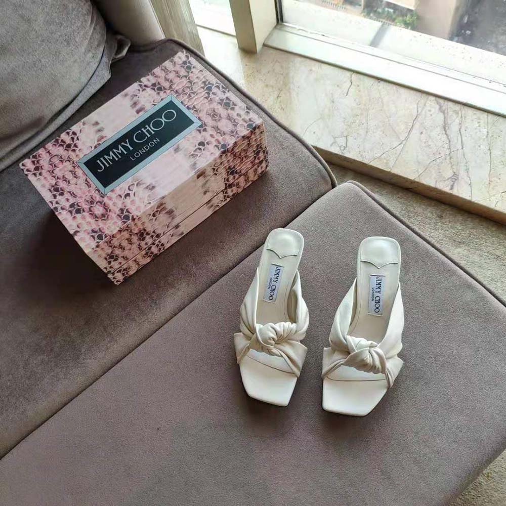Close-up of white nappa leather and heel detail on Jimmy Choo mules