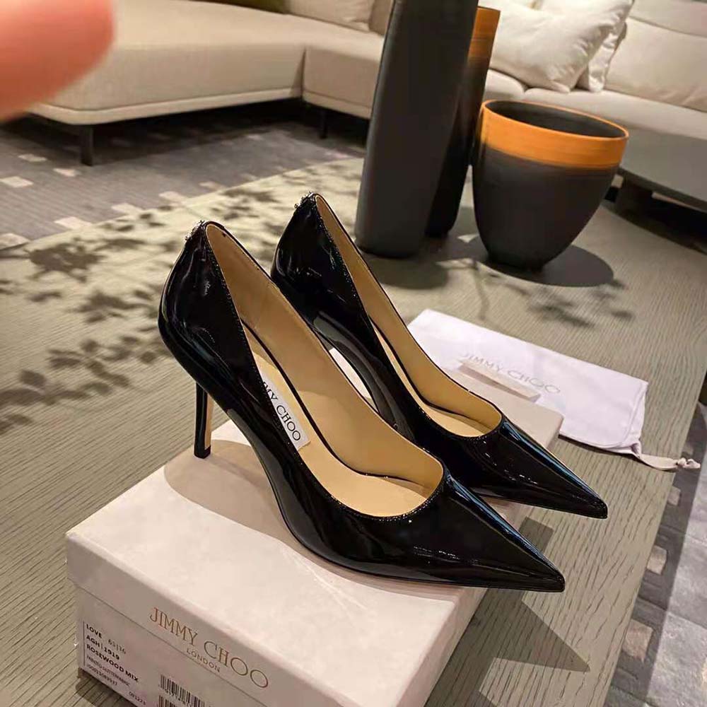Side profile showing heel height of Jimmy Choo Women Love 100 Black Patent Leather Pumps