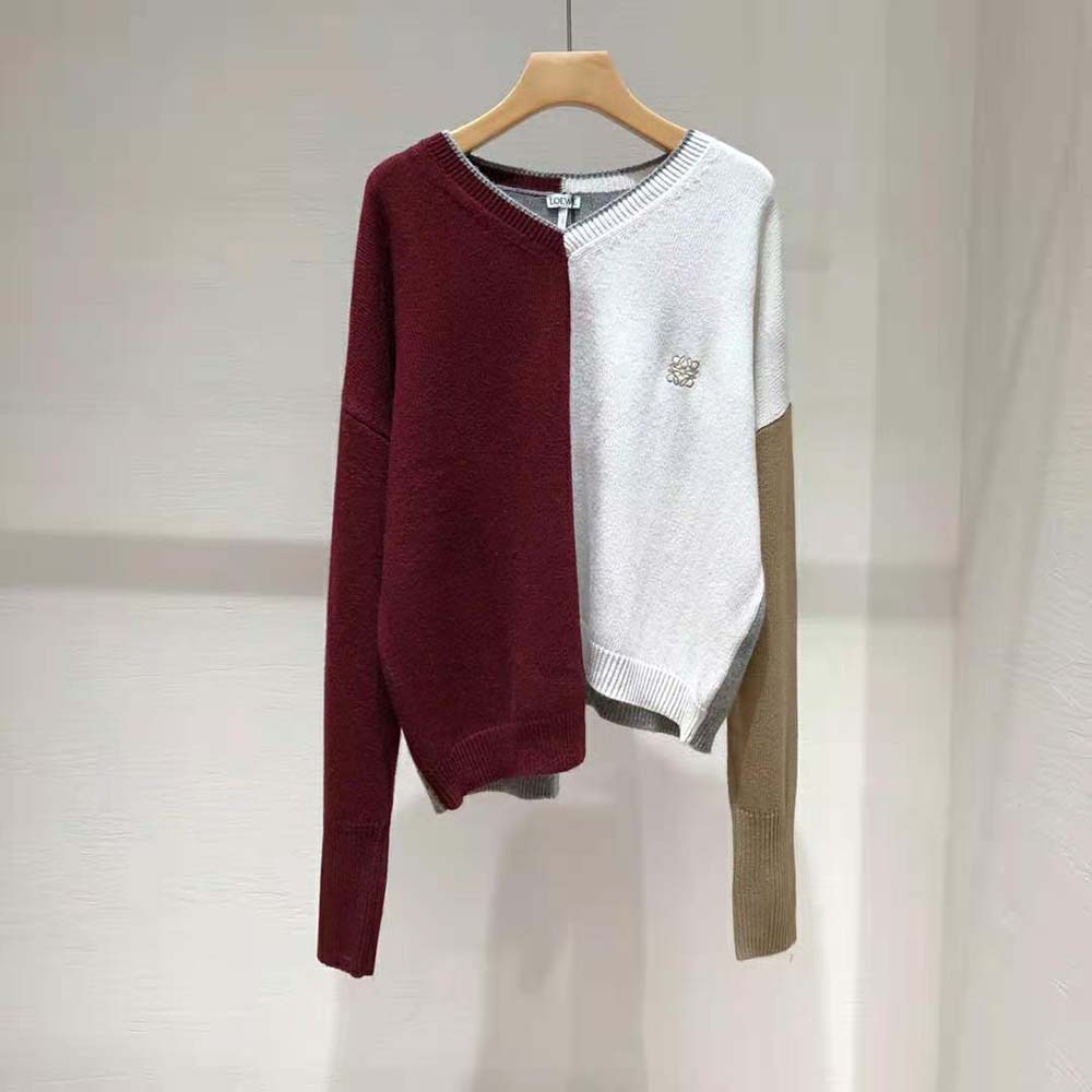 Close-up on Loewe Anagram embroidery detail on maroon wool sweater