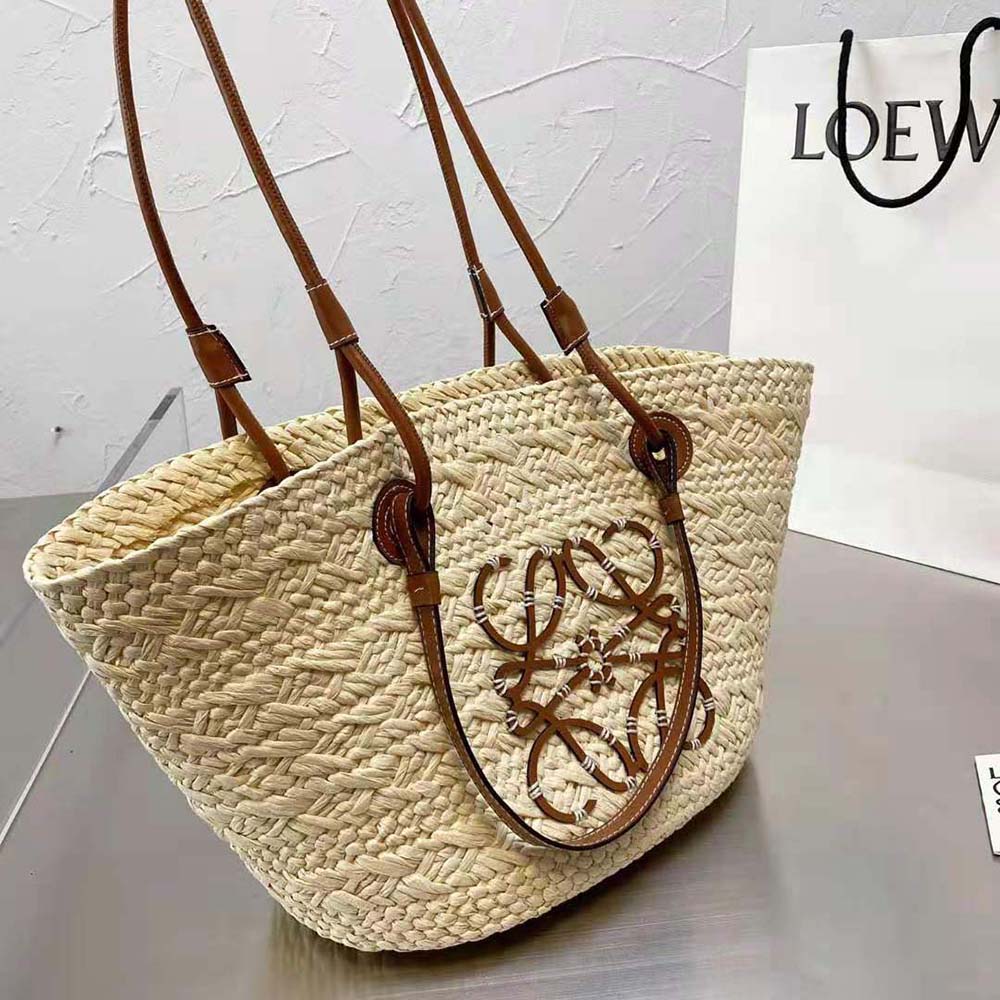 Side view showing woven Iraca palm texture on Loewe Medium Anagram Basket Bag