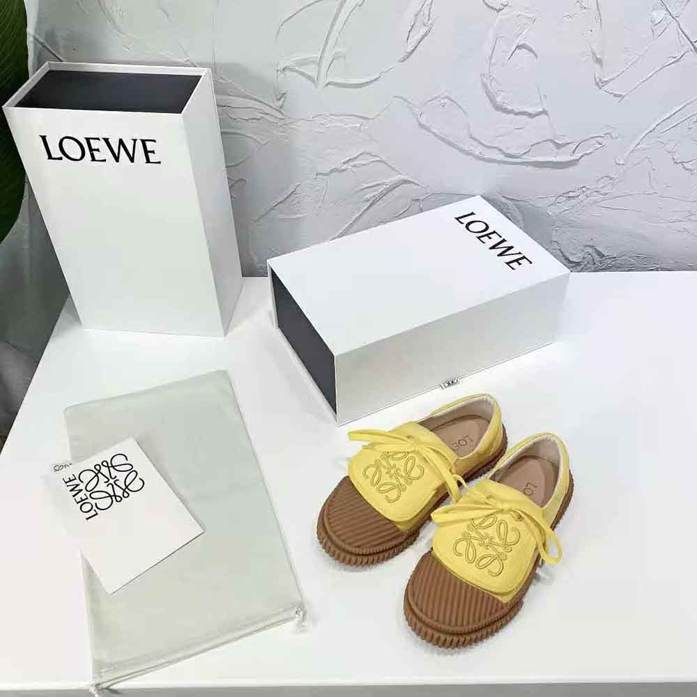 Close-up on yellow canvas and Anagram flap detail of Loewe sneaker