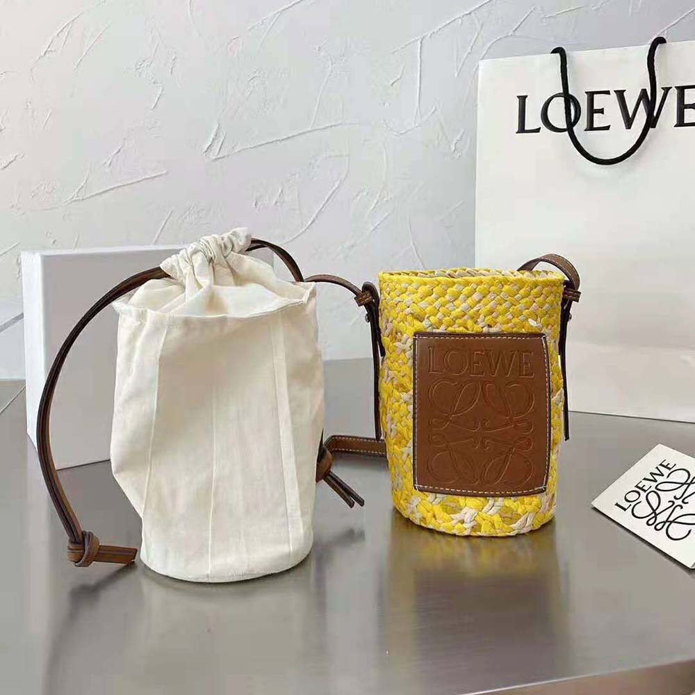 Side profile showing gold hardware and cylinder shape of Loewe bag