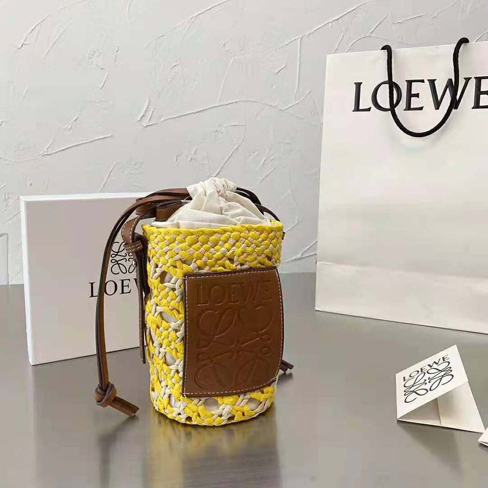 Close-up of woven Iraca palm and yellow calfskin on Loewe bag