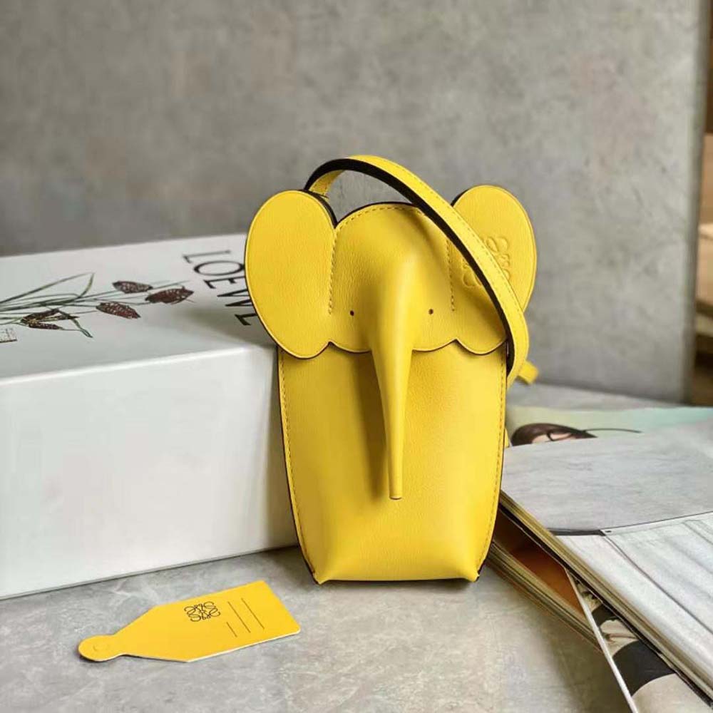 Close-up of signature Elephant Pocket hardware on Classic Calfskin-Yellow bag