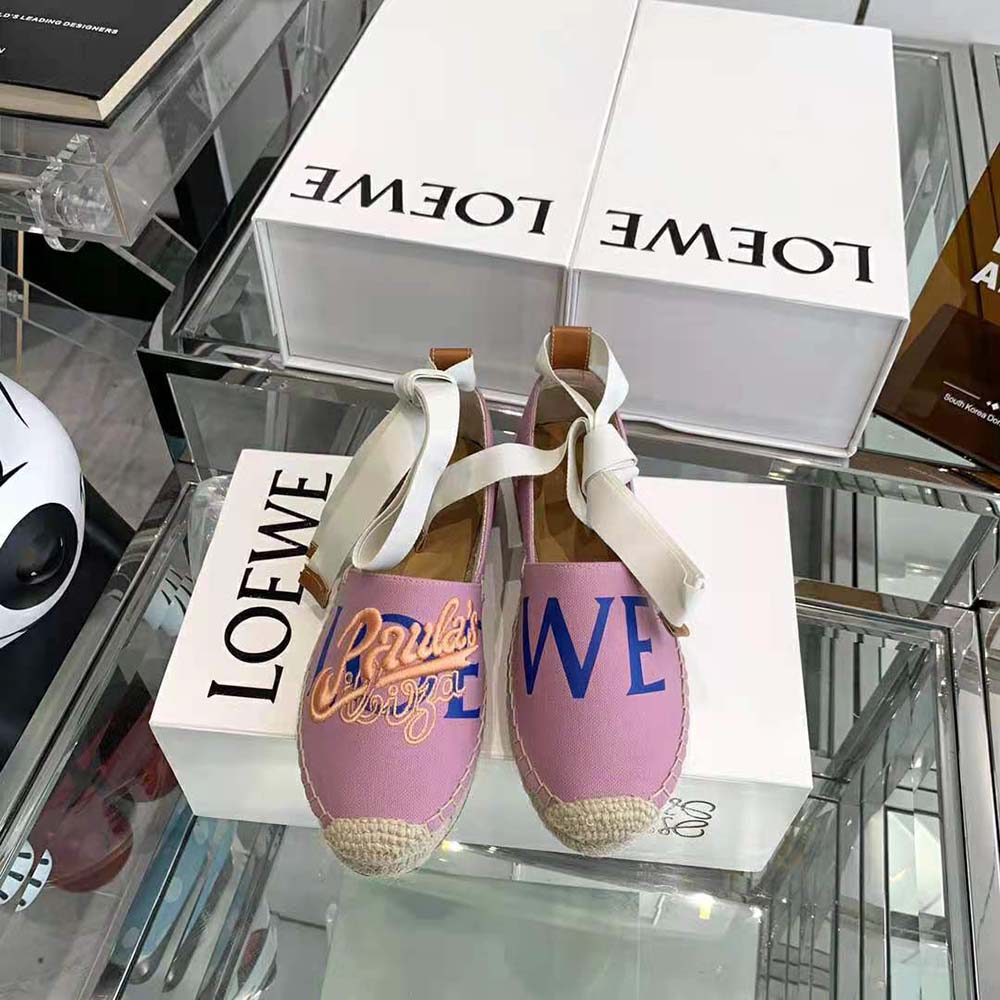 Close-up on Loewe embossed leather tab of pink espadrille loafer