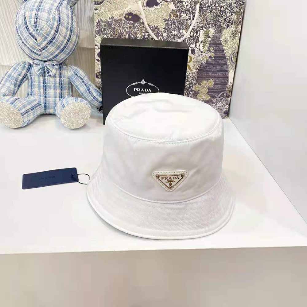 Close-up of Prada triangle logo on white nylon bucket hat
