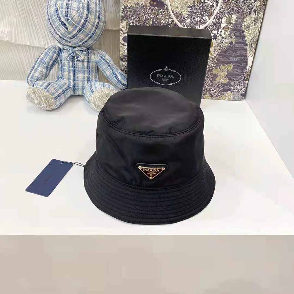 Close-up detail of Prada triangle logo on black nylon bucket hat