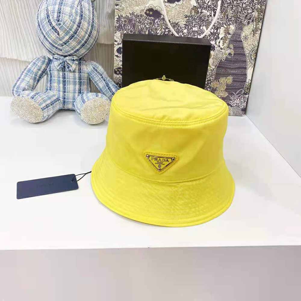 Close-up of metal triangle logo on Prada Women Nylon Bucket Hat Yellow