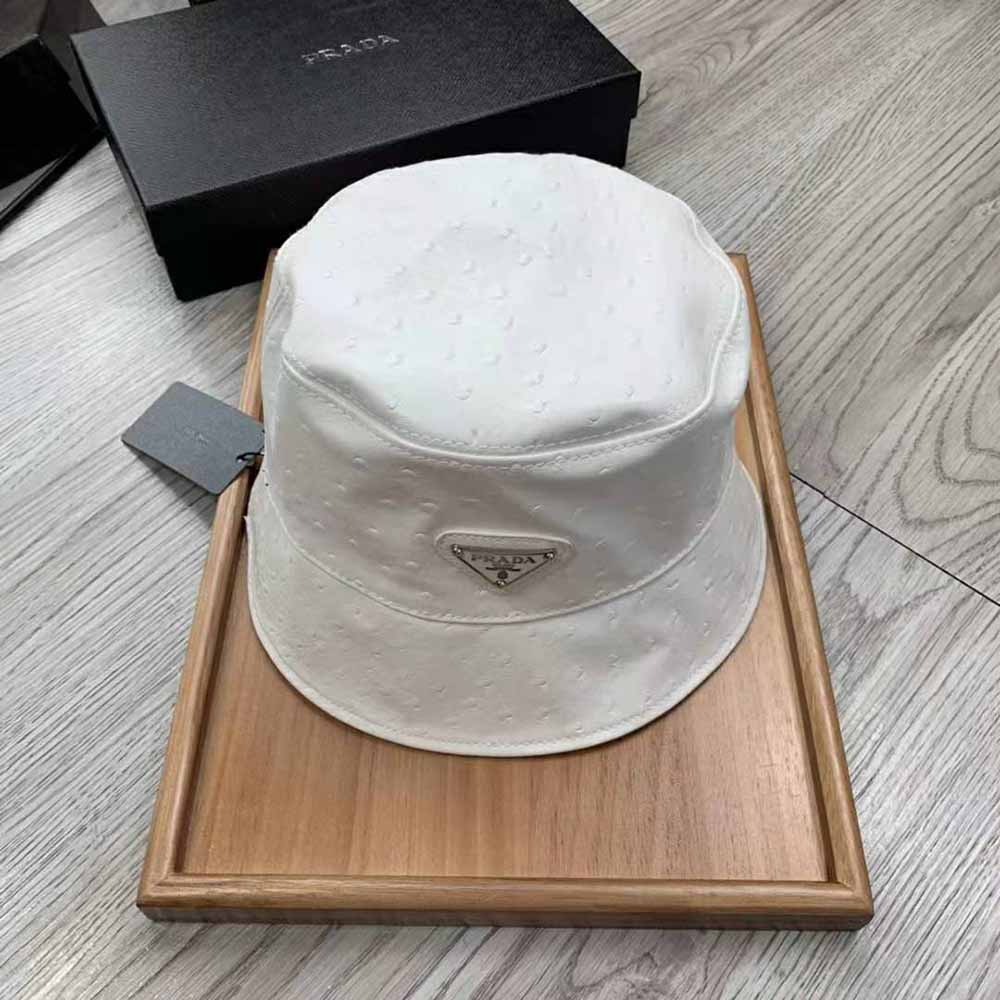 Close-up detail of white ostrich leather texture on Prada bucket hat
