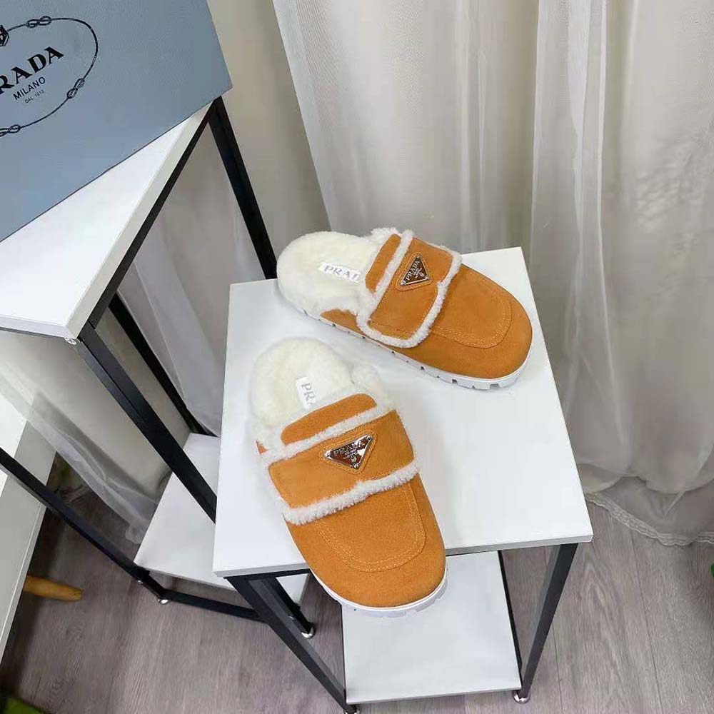 Top view showing plush shearling lining inside Prada yellow slippers