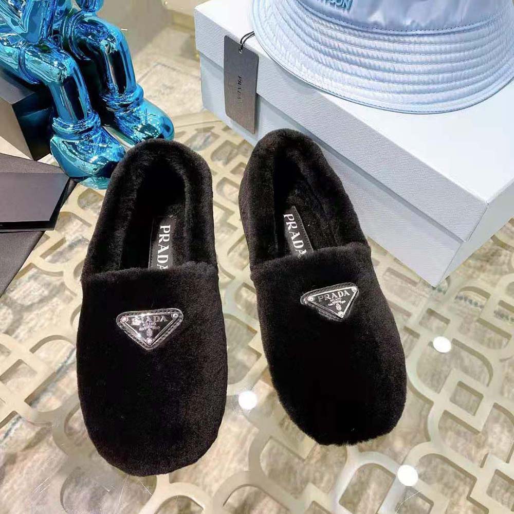 Close-up of shearling interior and Prada logo on slippers