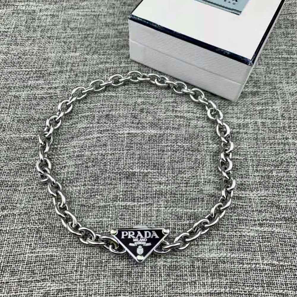 Close-up of black enamel and sterling silver details on Prada Women Symbole Necklace