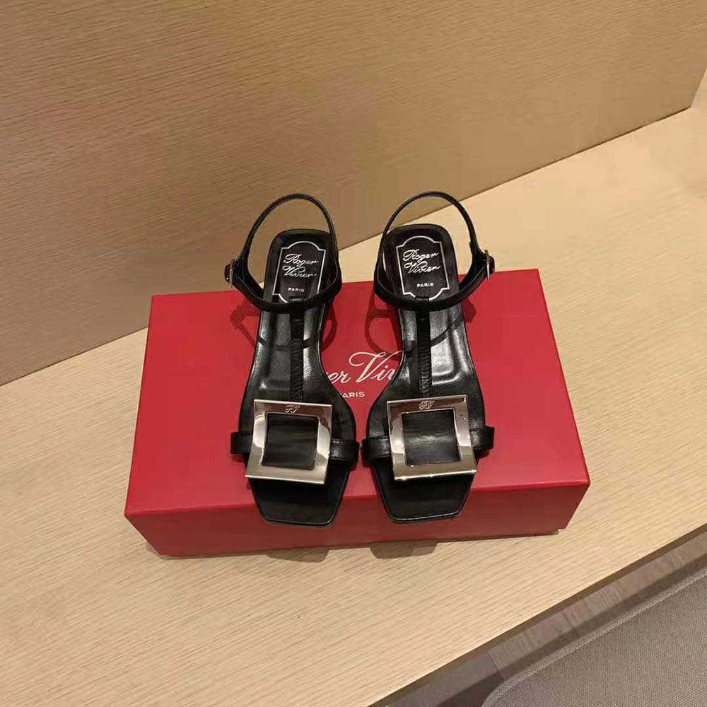 Angled front view showing leather texture of Roger Vivier black sandals