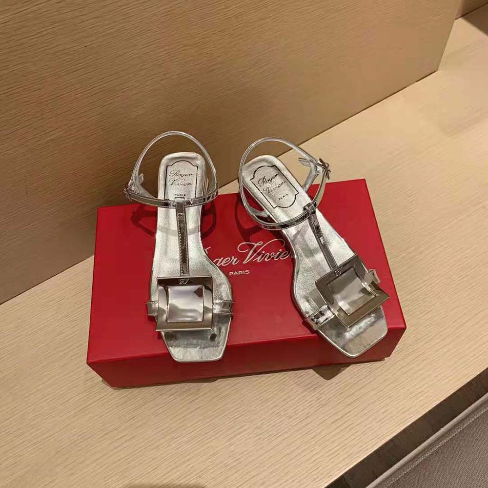 Close-up of signature metal buckle detail on Roger Vivier sandals