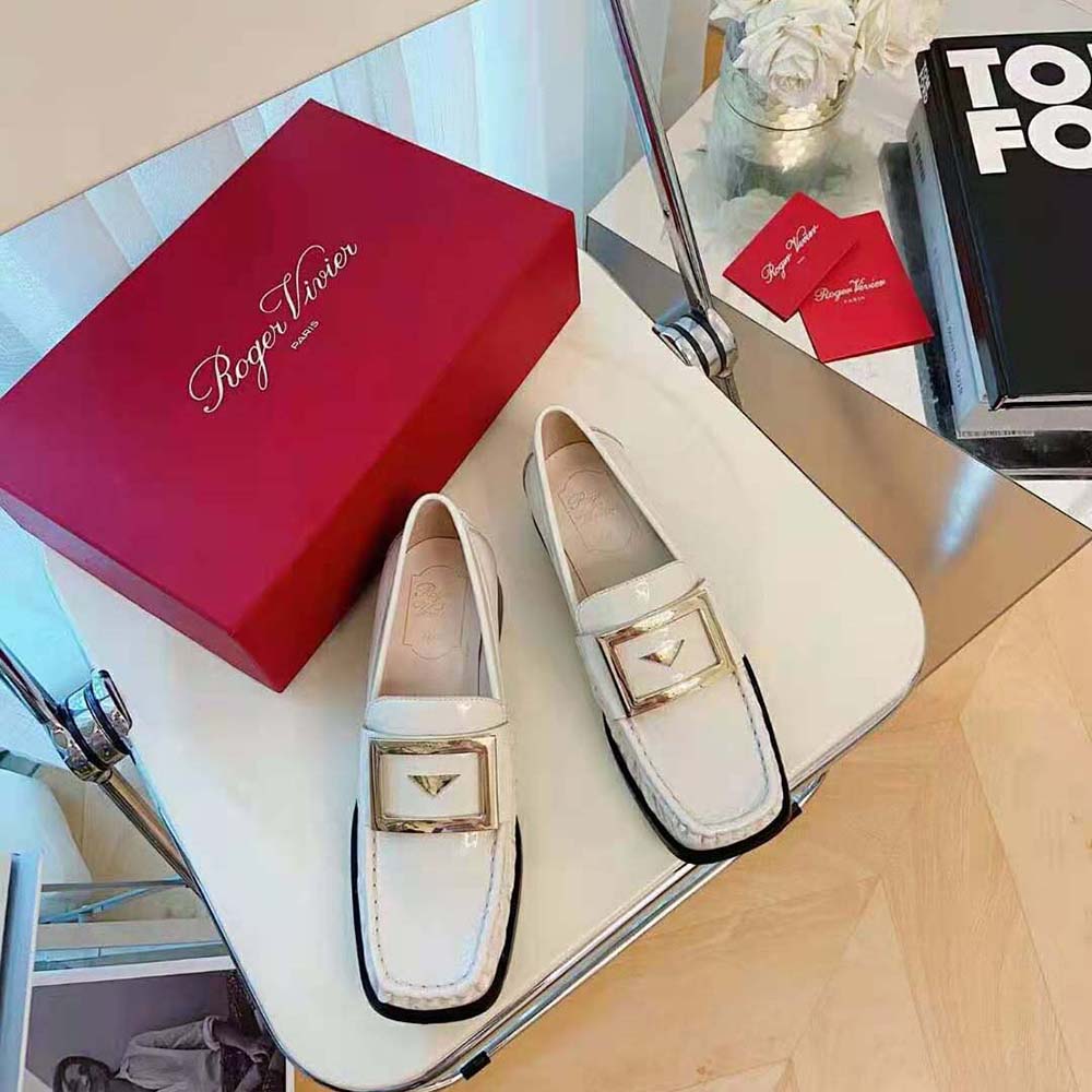 Close-up of metal buckle detail on Roger Vivier Preppy Loafers in white patent leather