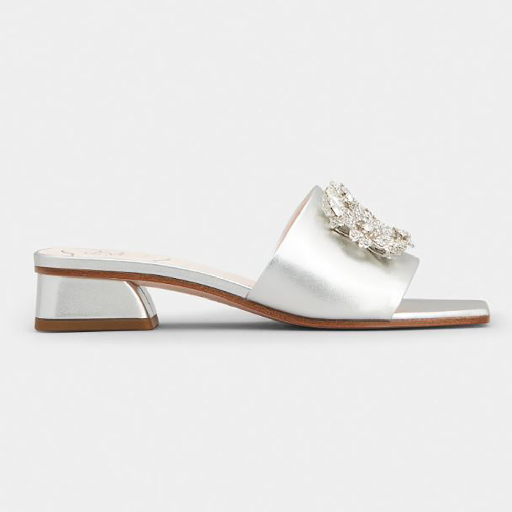 Side profile of Roger Vivier Women RV Bouquet Strass Buckle Mules in silver leather