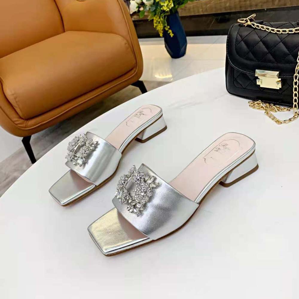 Close-up of sparkling strass bouquet buckle on Roger Vivier soft leather mules