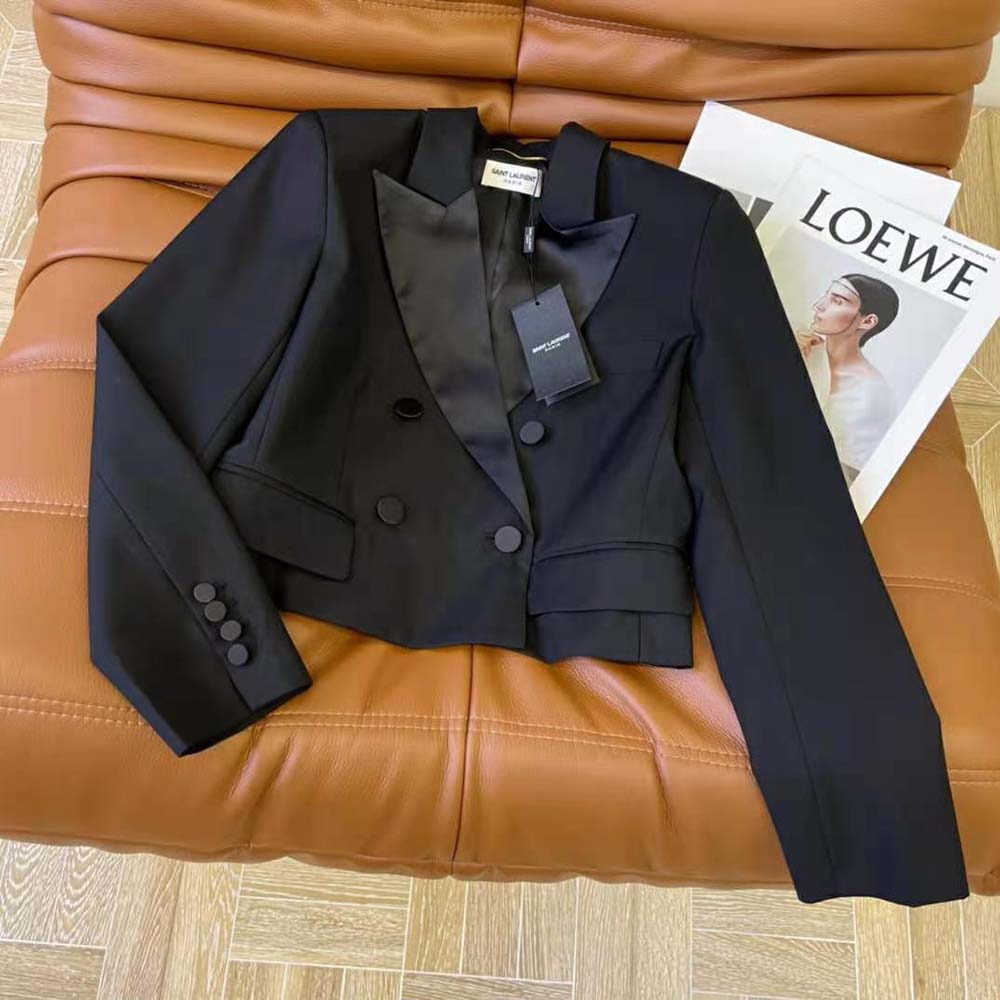 Close-up on signature YSL button hardware and grain DE Poudre fabric texture