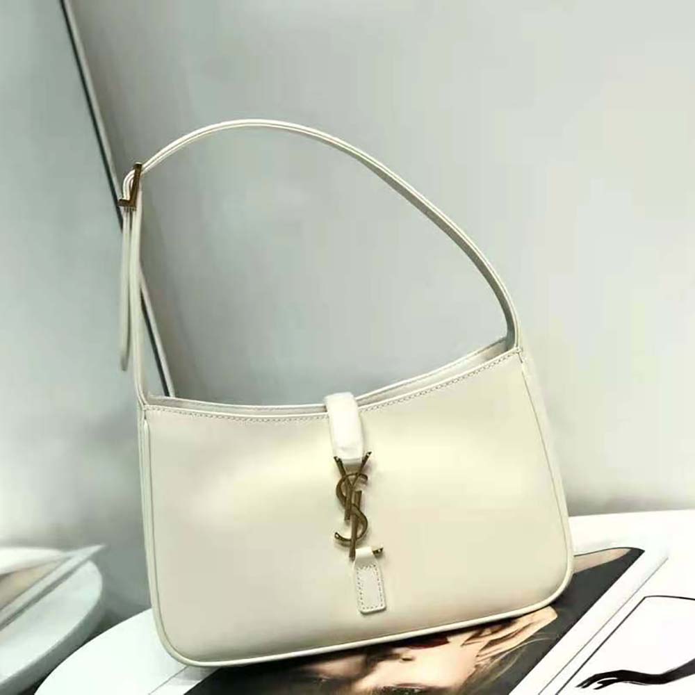 Close-up on gold YSL logo hardware detail of Saint Laurent YSL Hobo Bag