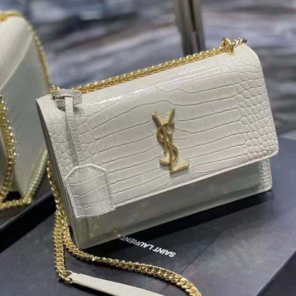 Side angle showing adjustable strap and shiny leather texture on Saint Laurent bag
